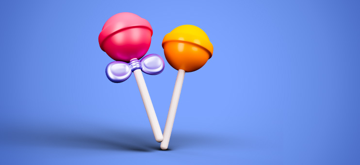 Image of two colorful lollipops on a blue background. The lollipops are positioned in the center of the image, and they are the main focus.